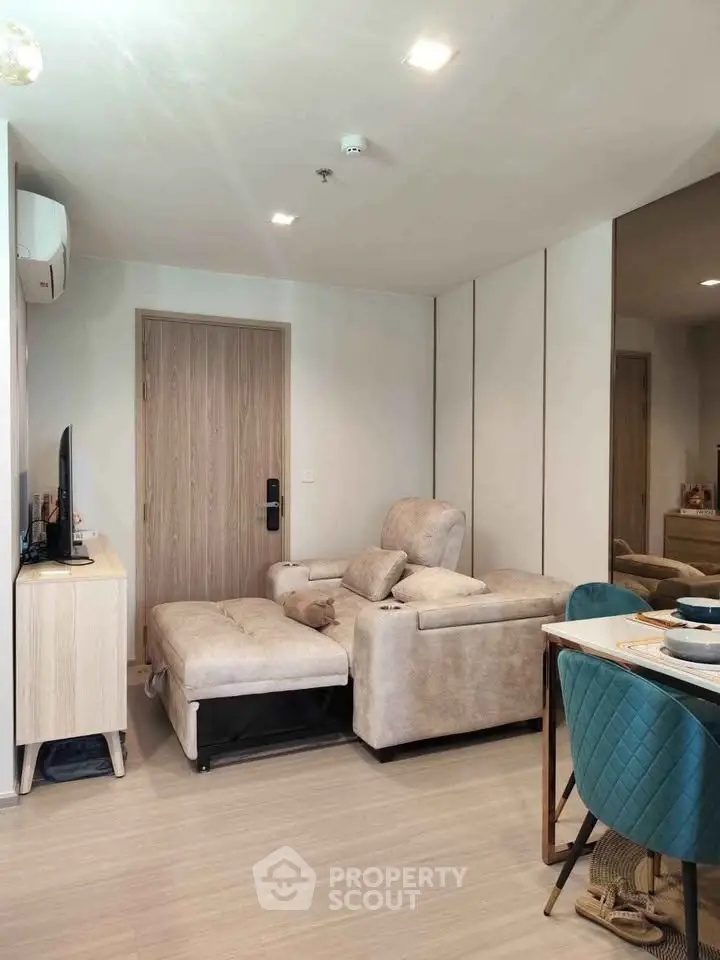 Modern living room with cozy seating and stylish dining area in a contemporary apartment.