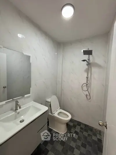 Modern bathroom with sleek fixtures and tiled walls in a contemporary home.