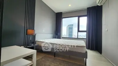 Modern bedroom with city view, featuring sleek design and ample natural light.