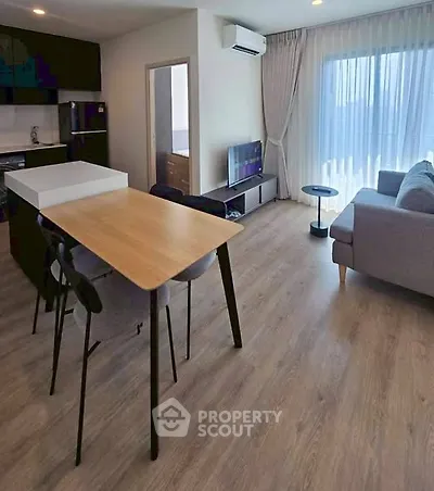 Modern open-plan living room with sleek kitchen and stylish furnishings