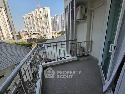 Spacious balcony with city view in modern apartment complex