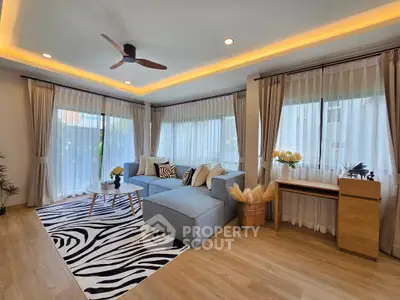 Spacious living room with modern decor and large windows for natural light.