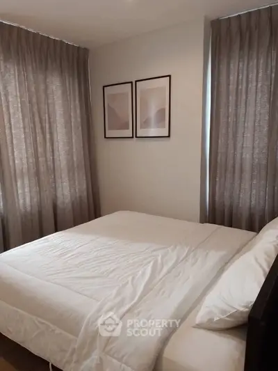 Cozy bedroom with modern decor and soft lighting, featuring a comfortable bed and elegant curtains.