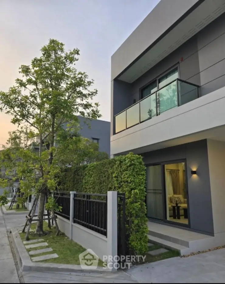 Modern architectural home exterior with lush greenery and sleek design.