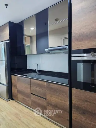 Modern kitchen with sleek wooden cabinets and built-in appliances