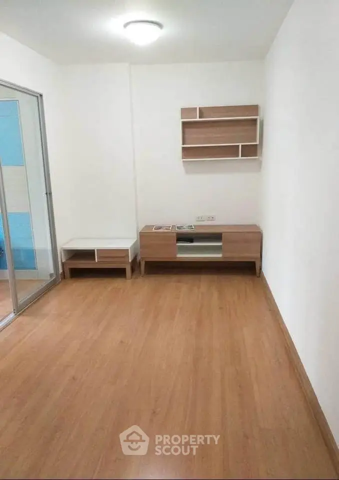 Modern minimalist living room with wooden flooring and sleek furniture.