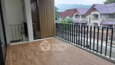 Spacious balcony with wooden flooring and scenic neighborhood view