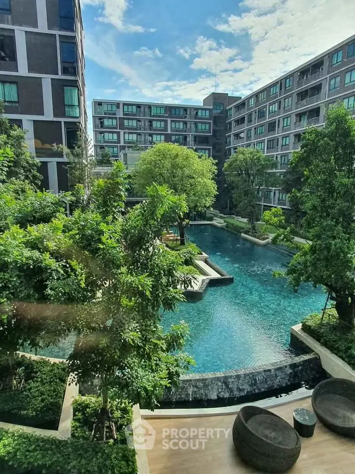 Luxurious residential complex with stunning pool and lush greenery, perfect for modern living.