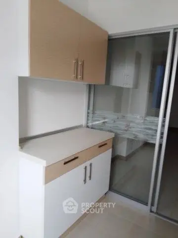Modern kitchen with sleek cabinetry and sliding glass doors