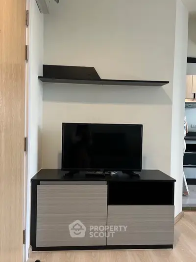 Modern living room with sleek TV stand and wall shelf