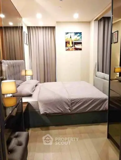 Modern bedroom with cozy lighting and elegant decor, featuring a comfortable bed and stylish artwork.