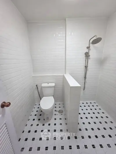 Modern minimalist bathroom with white tiles and walk-in shower