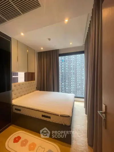 Modern bedroom with large window and city view, featuring stylish decor and cozy ambiance.