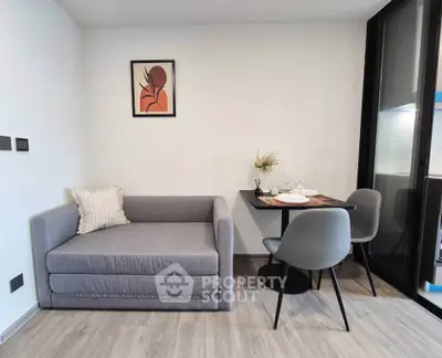 Modern living room with stylish sofa and dining area in a contemporary apartment.