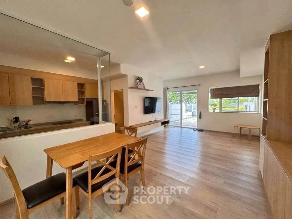 Spacious open-plan living room with dining area and modern kitchen.
