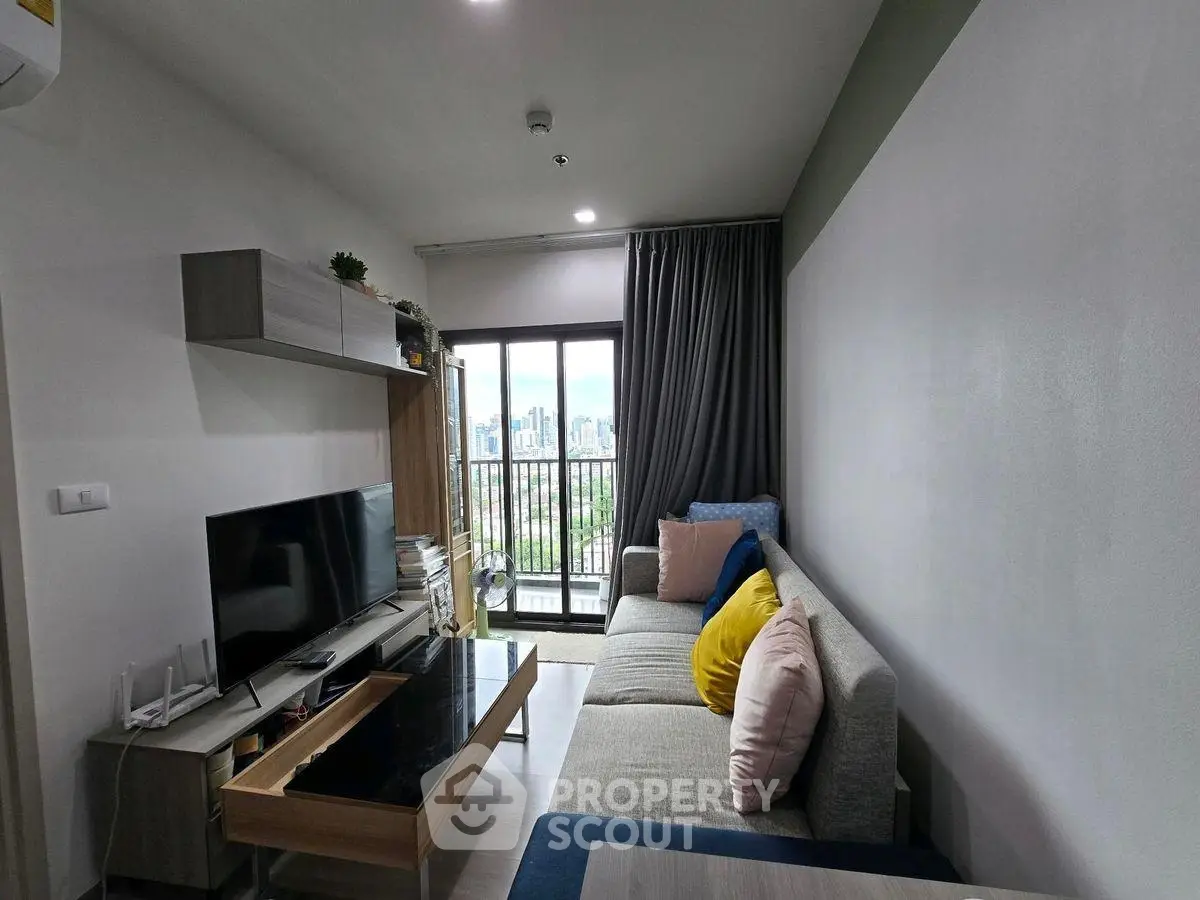 Modern living room with city view, stylish furniture, and cozy ambiance.