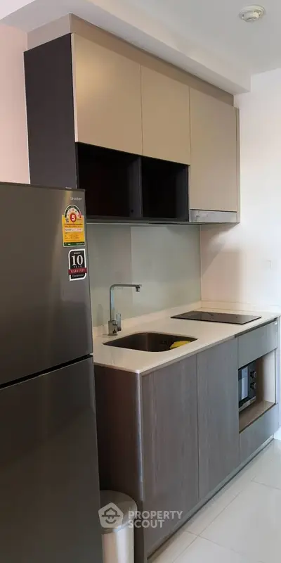 Modern compact kitchen with sleek cabinetry and stainless steel appliances