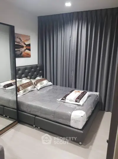 Modern bedroom with elegant gray decor and mirrored wardrobe