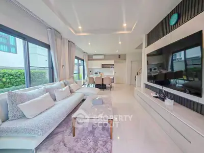 Spacious modern living room with large windows and elegant decor