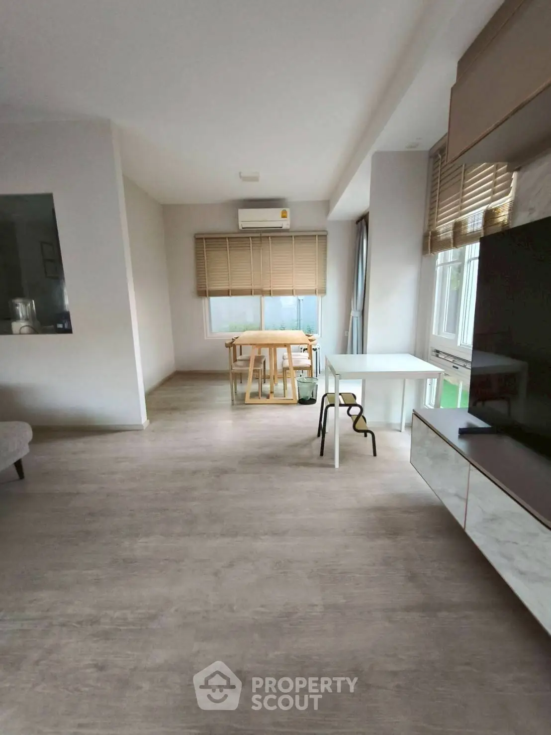 Modern living room with minimalist decor and large windows