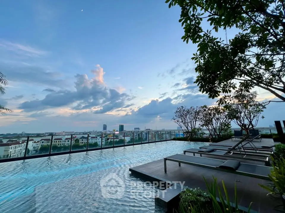 Stunning rooftop pool with panoramic city views at sunset, perfect for relaxation and luxury living.