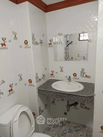 Charming bathroom with animal-themed tiles and modern fixtures, perfect for a playful touch.