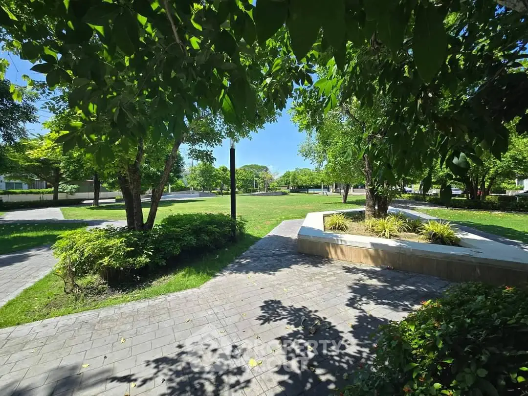 Lush green garden with paved pathways and vibrant landscaping