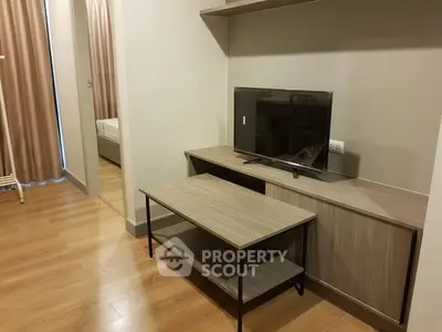 Modern living room with wooden flooring and sleek TV stand, perfect for cozy urban living.