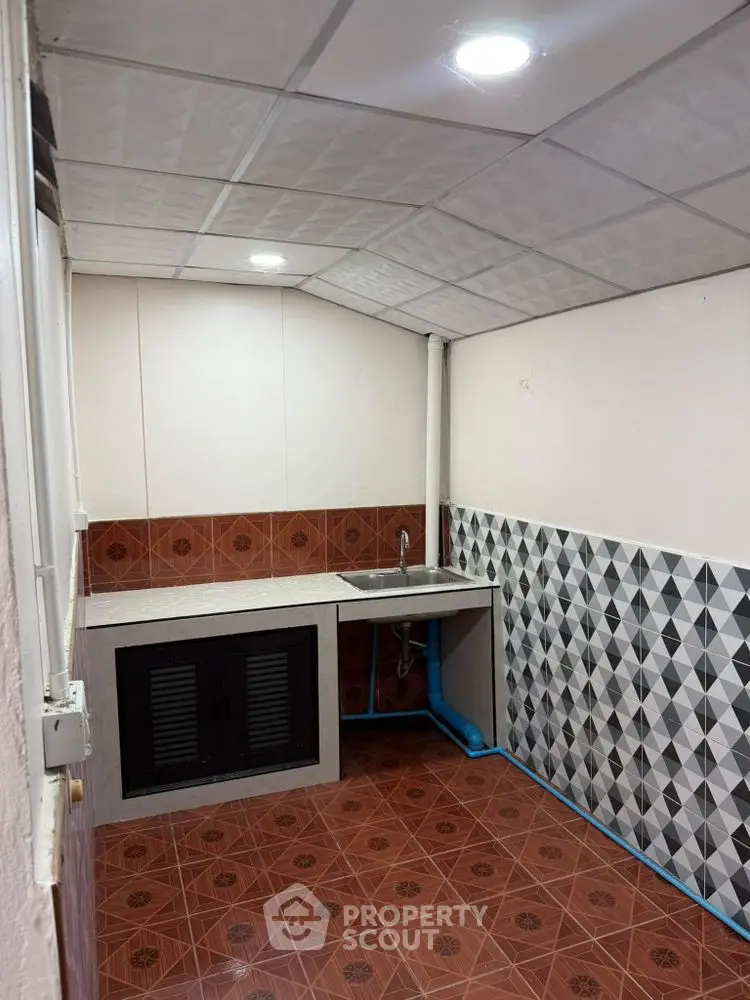 Charming kitchen with unique tile design and compact layout, perfect for efficient cooking in cozy spaces.