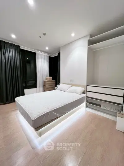 Modern bedroom with sleek design and ambient lighting