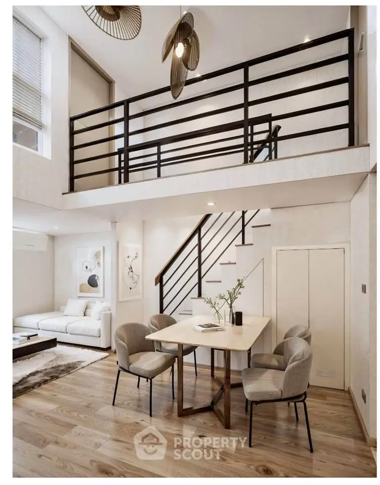 Modern duplex living room with elegant dining area and stylish staircase