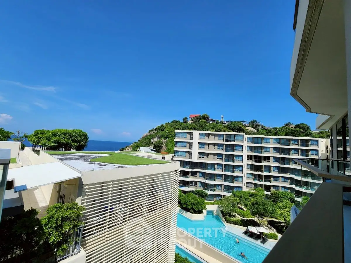 Luxurious ocean-view condominium with pool and lush greenery, perfect for serene living.