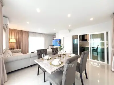 Luxurious open-plan living and dining area with elegant decor and natural light.