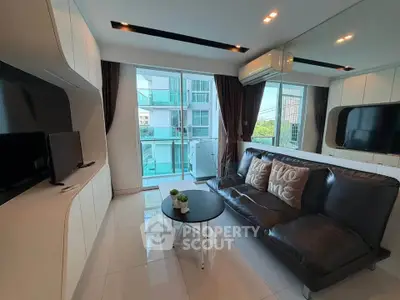 Modern living room with sleek design and large windows offering natural light and a view.