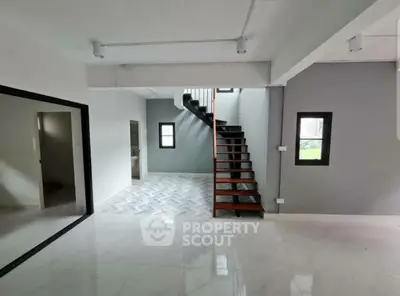 Modern interior with sleek staircase and open layout, perfect for contemporary living.
