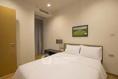 Cozy bedroom with minimalist decor and soft lighting, perfect for relaxation.