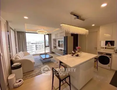 Modern open-layout living room with kitchen island and city view in luxury apartment.