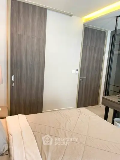 Modern bedroom with sleek wooden sliding doors and cozy bedding