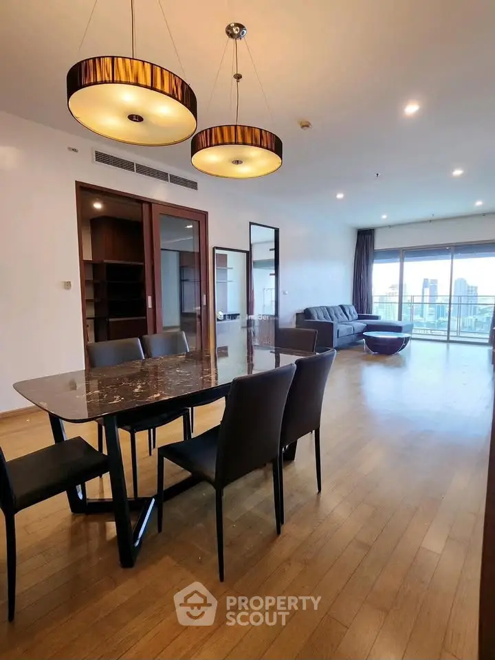 Spacious modern living room with elegant dining area and city view balcony.