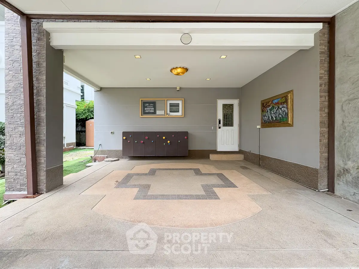 Spacious covered parking area with elegant lighting and decorative wall art.