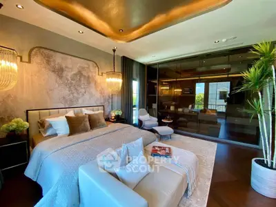 Luxurious bedroom with elegant decor and large glass doors opening to a scenic view.