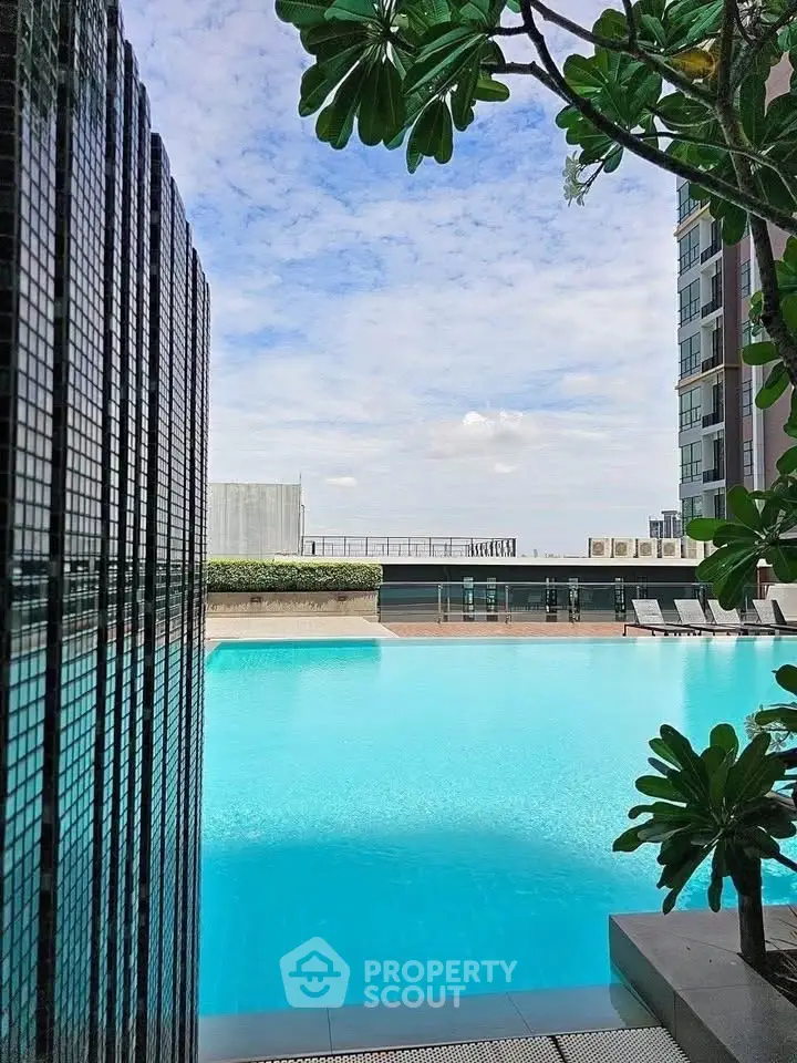 Luxurious rooftop pool with stunning city views and lush greenery, perfect for relaxation and leisure.