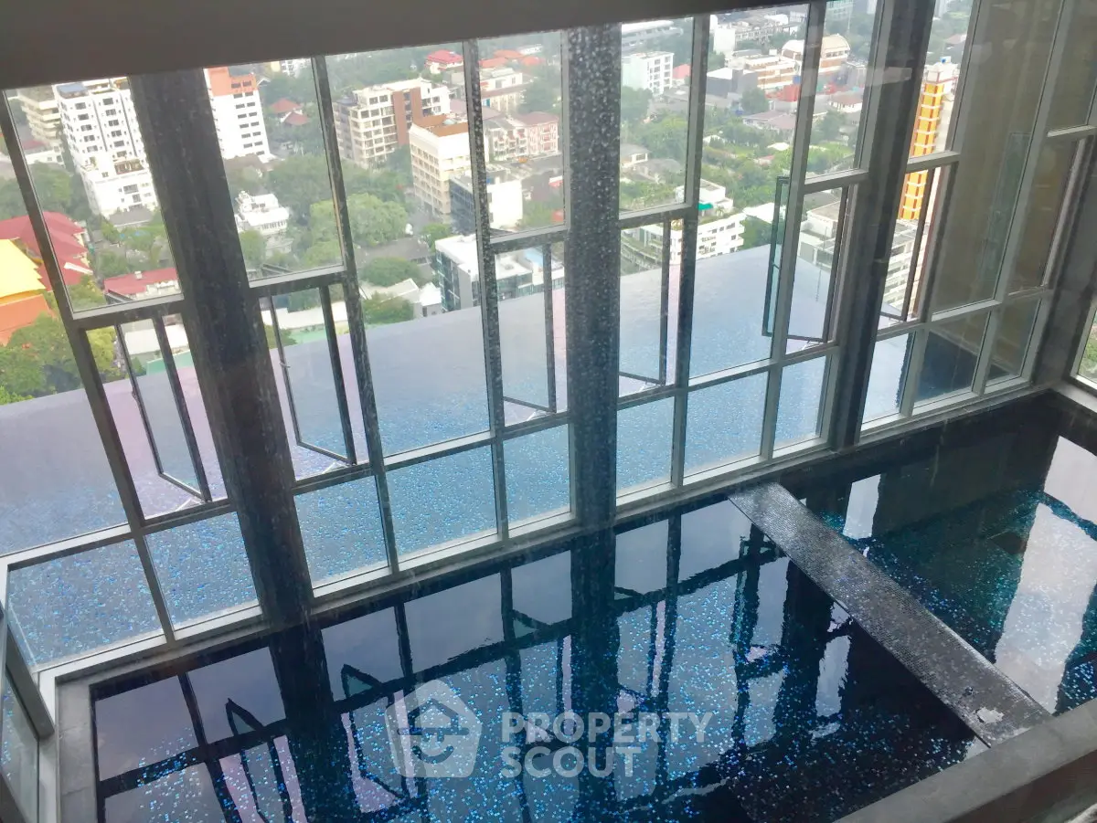Luxurious high-rise building with stunning infinity pool and panoramic city views.