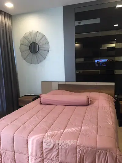 Modern bedroom with stylish decor and cozy bedding in a contemporary apartment.