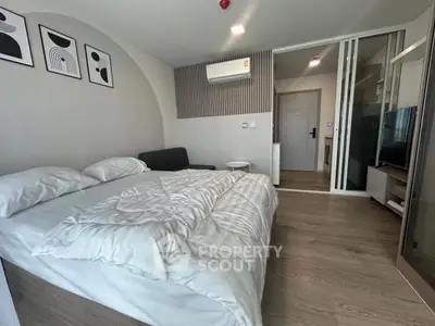 Modern bedroom with cozy bed, stylish decor, and air conditioning in a contemporary apartment.