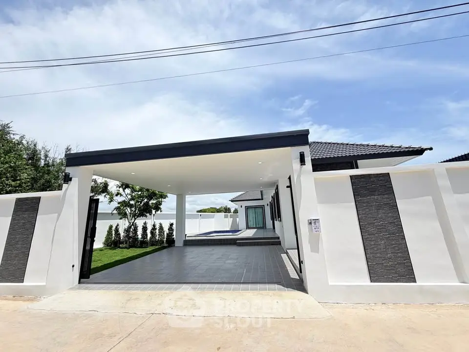Modern single-story home with sleek design and spacious driveway