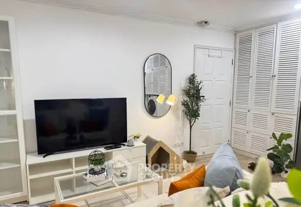 Charming living room with modern decor, TV setup, and cozy seating area.