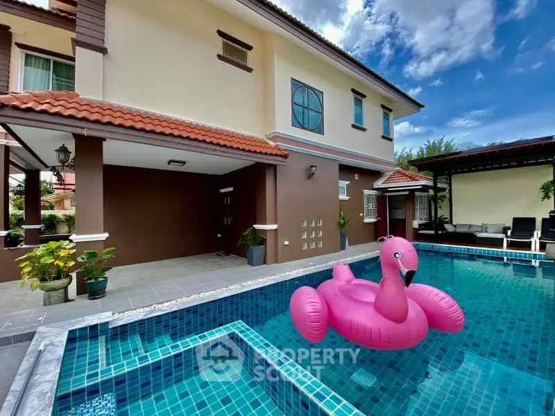 Luxurious villa with private pool and pink flamingo float, perfect for relaxation and entertainment.