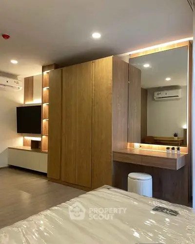 Modern bedroom with stylish wooden wardrobe and sleek vanity area