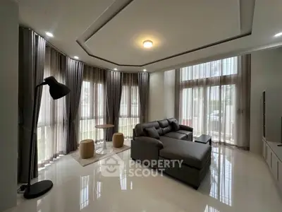 Spacious modern living room with large windows and elegant decor